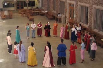 Photo of a circle of dancers in historical costume